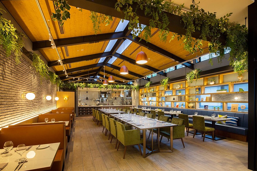 A restaurant with tables and chairs.